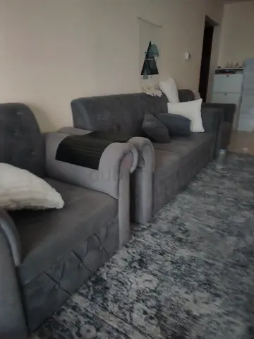 Grey 3-seater sofa with matching armchair and pillows - good condition