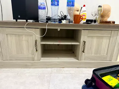 Light wood TV entertainment cabinet with storage shelves and cabinets