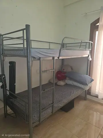 Metal bunk bed (double size bottom, single top) - good condition with medicated mattress.