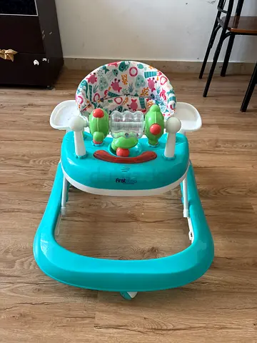 Lightweight turquoise baby walker with activity tray