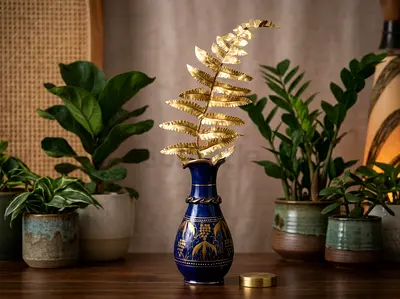 Decorative blue glass vase with gold fern arrangement - like new