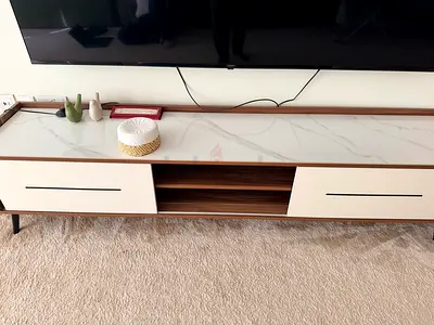 Low wooden TV unit with white marble-effect top and storage drawers