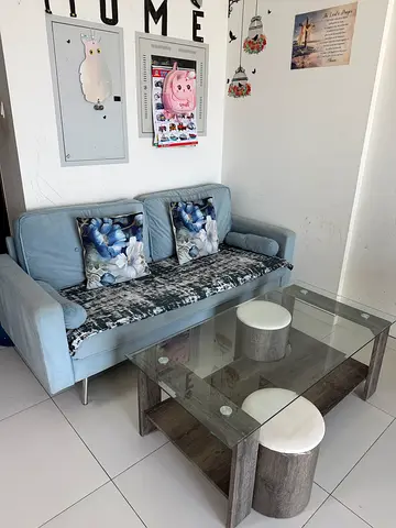 Light blue 3-seater sofa with glass coffee table and ottomans