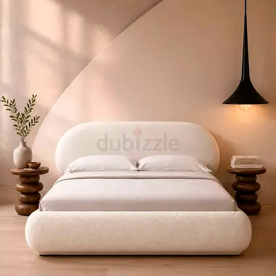 Cream upholstered Queen-size bed with rounded headboard and footboard