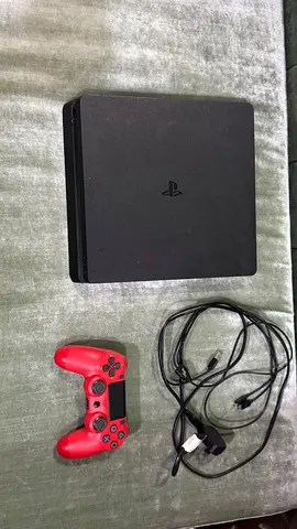 PlayStation 4 Slim with DualShock controller and power/USB cables