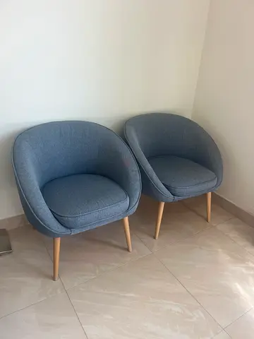 Pair of modern blue fabric accent chairs with wooden legs