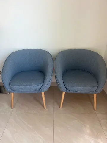 Pair of modern blue fabric accent chairs with wooden legs