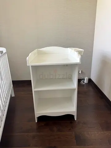 White baby changing table with open shelves