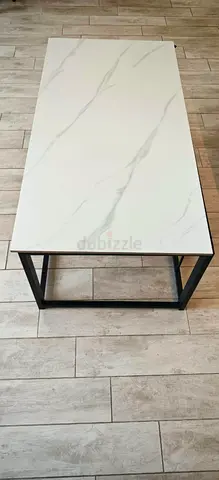 Modern rectangular coffee table with white marble top and black metal frame