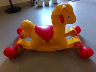 Yellow plastic rocking horse with detachable wheels - good condition