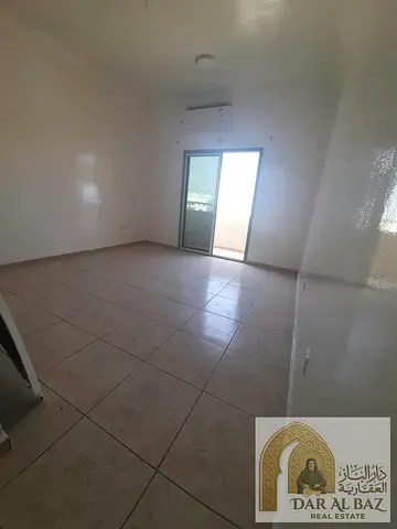 Studio for annual rent in the Al Majara area, Sharjah. The studio features a spacious layout, a separate bathroom, a semi-separate kitchen, and an ope