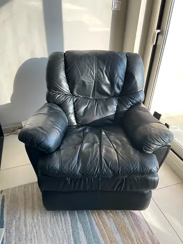Black leather recliner armchair in good used condition
