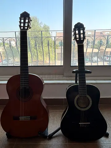 Two classical nylon-string acoustic guitars - black and brown, Yamaha C40 & Start N6
