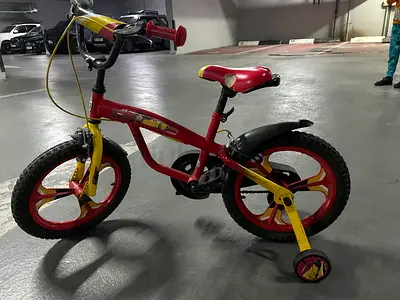 Red & yellow kids bicycle with training wheels - good condition.