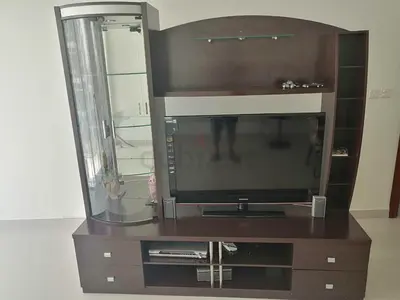 Dark wood entertainment center with glass display cabinet