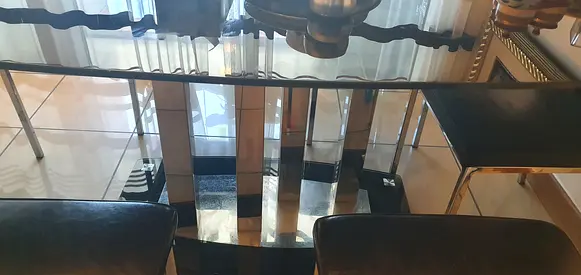 Black six seater dining table with six chairs
