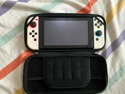 Nintendo Switch (neon white Joy‑Con) with travel case - good condition