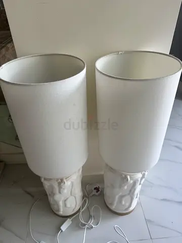 Pair of white ceramic table lamps with fabric shades and horse detail