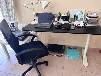 3 IKEA desks, one with adjustable height, another a corner computer table and 3rd a standard desk.