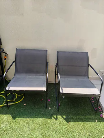 Pair of outdoor metal frame mesh lounge chairs
