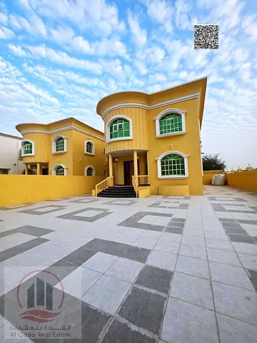 Villa for sale in Ajman, Al Muwaihat, including electricity and water. 5 master bedrooms, living room, majlis, and maid's room. Freehold ownership for