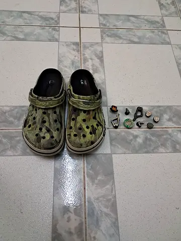 Used green camo slip-on clogs with Jibbitz charms - size unknown