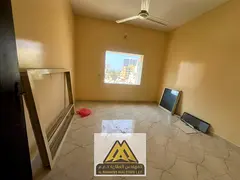2BR for annual rent in Al Rashidiya 3, Ajman. Separate living room, 1 bath, balcony, split AC, and p