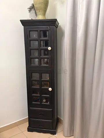 Tall dark wooden cabinet with glass doors and drawers - good condition