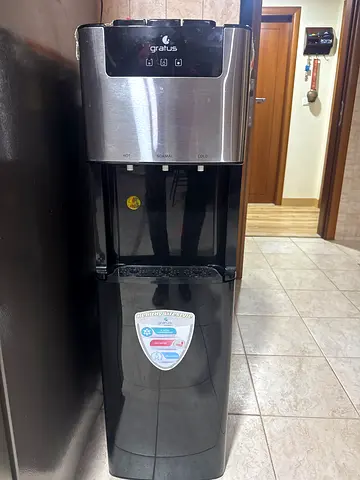 Black freestanding water dispenser with hot and cold taps - used