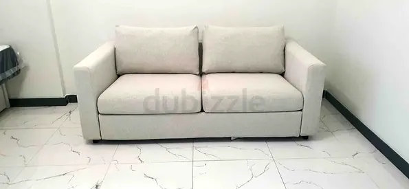Light beige 2-seater sofa bed in good condition