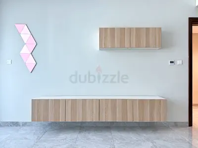 Wall-mounted floating TV console and storage cabinets - light wood finish