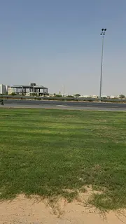 Commercial plot for sale in Al Tay Commercial Project (Al Raqiba Commercial), located directly on Em