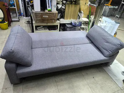 Grey fabric convertible sofa bed with removable cushions