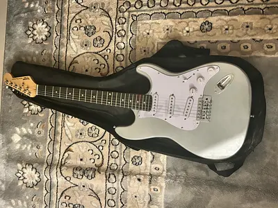 Silver electric guitar (Strat-style) with gig bag, cord included (CURRENTLY ON HOLD)