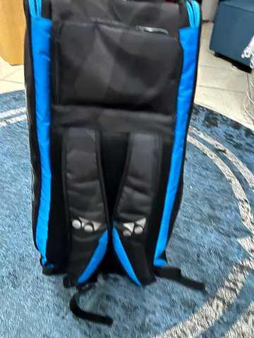 Blue and black tennis rackets and equipment backpack in good condition