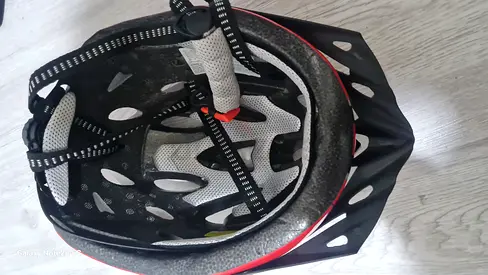 Used red and black bicycle helmet, size medium,good condition with helmet and bottle holder included