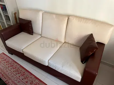 3+2 seater sofa with cream cushions and brown leather arms
