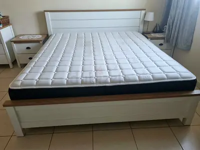 King size wooden bed frame with mattress and matching nightstands and dresser