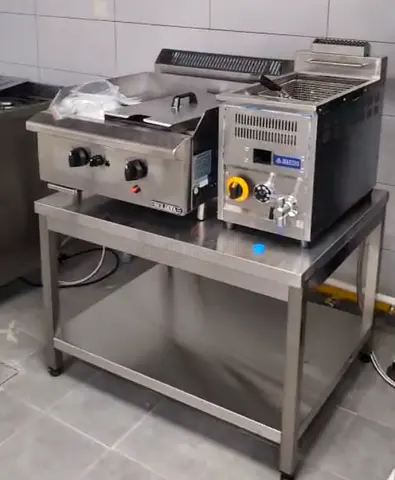 Griddle and fryer on stainless steel stand