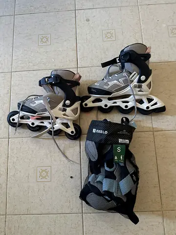 Used inline roller skates with protective gear, size S