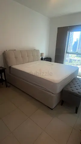 King size upholstered bed frame with mattress and storage, barely used.
