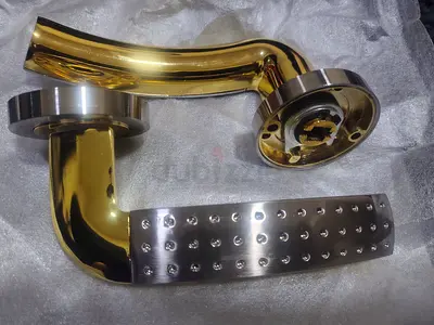 Set of two gold & stainless steel door lever handles - unused