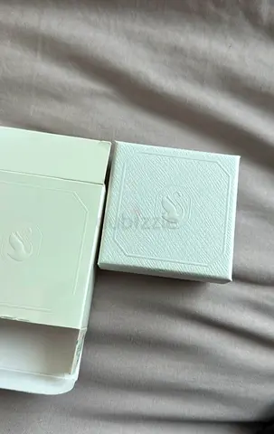 Small white jewelry box with embossed S logo