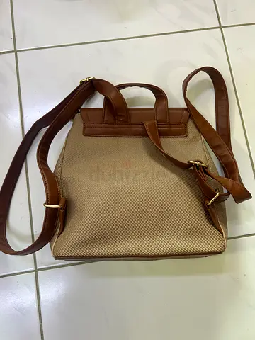 Beige and brown structured tote handbag with top handle and shoulder strap