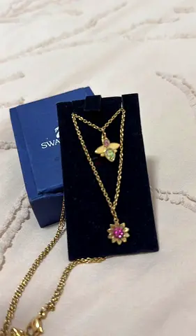 Gold-tone Swarovski layered necklace set with floral and butterfly pendants