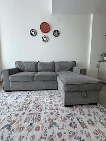 Gray L-shaped sofa bed with storage