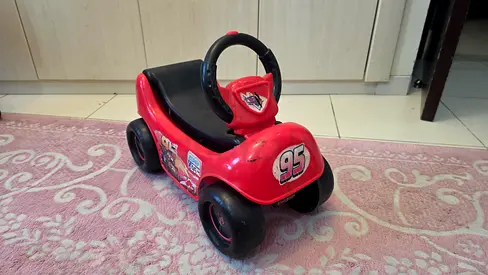 Red toddler ride-on car (Lightning McQueen style) - good condition