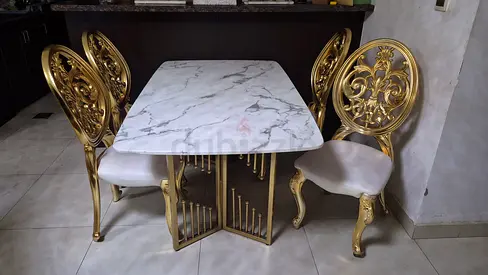 Marble-top dining table with 4 ornate gold chairs