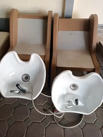 Pair of salon shampoo backwash chairs with ceramic basins - used