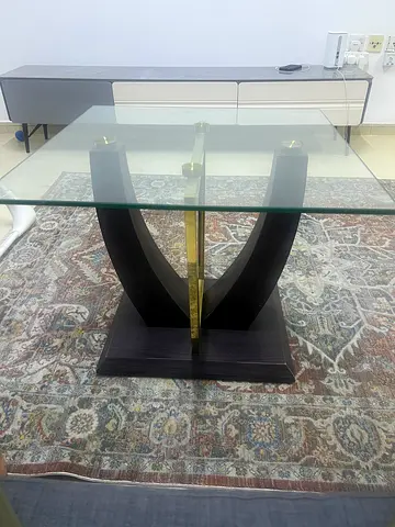 Glass Top Coffee Table with Curved Wooden Base and Brass Accents